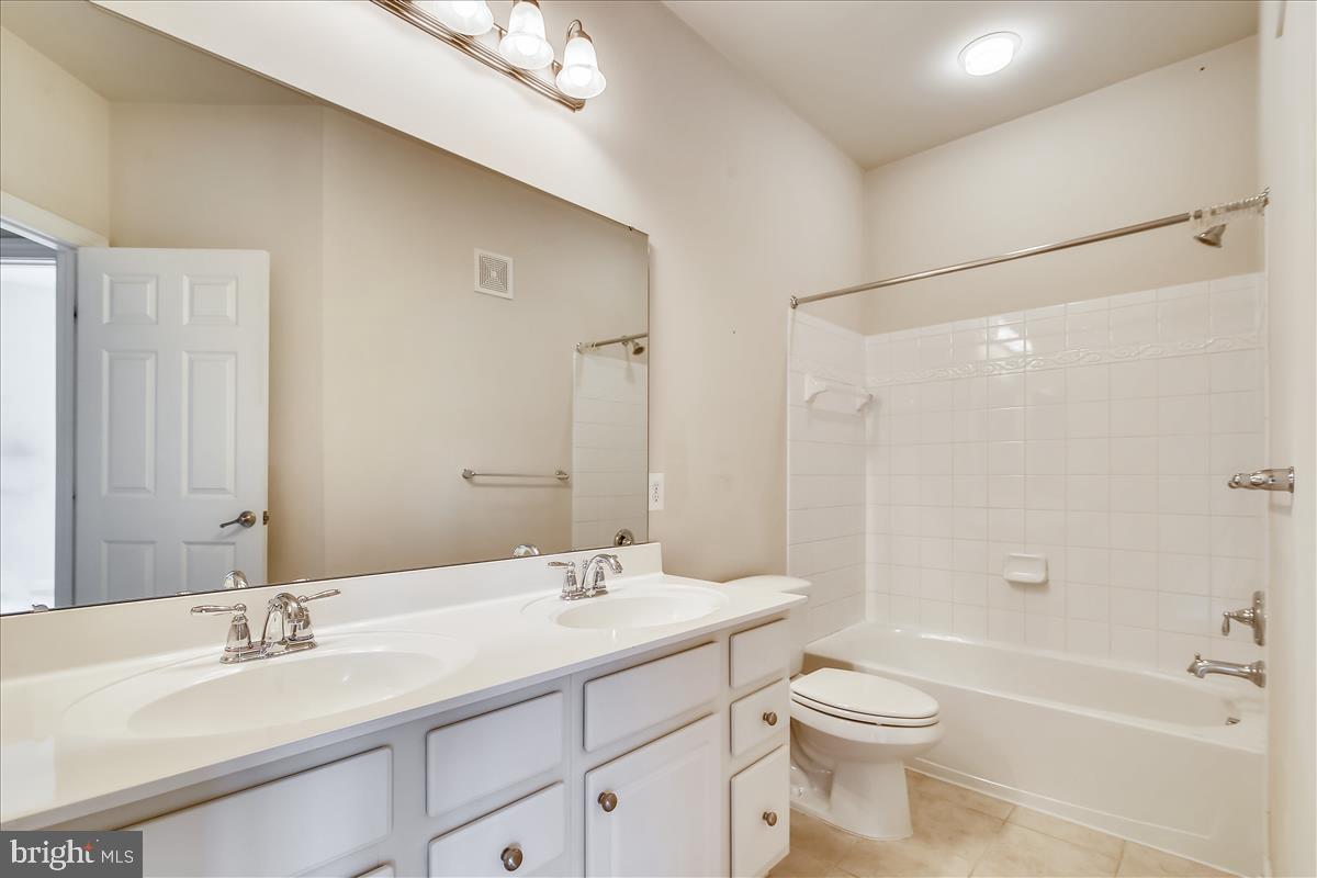 3602 Spring Hollow Lane Frederick, MD 21704 - Photo 20 of 25 a bathroom with a double vanity sink toilet mirror and bathtub