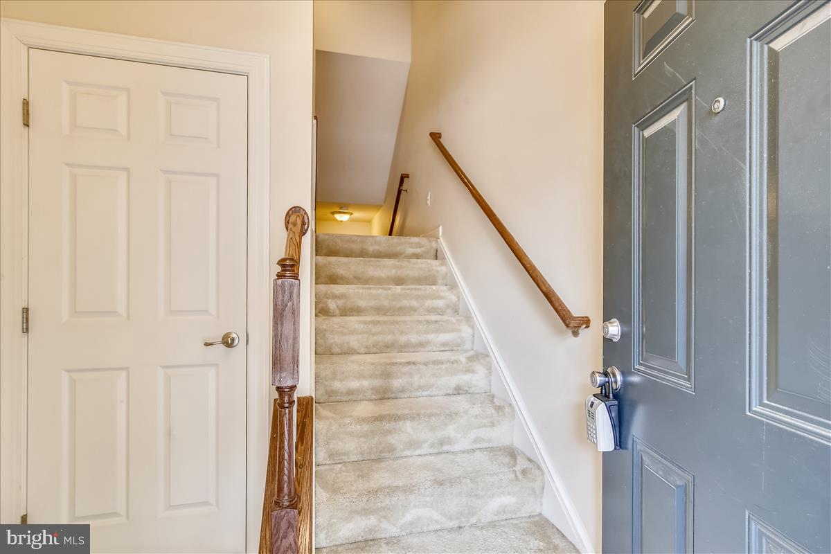 3602 Spring Hollow Lane Frederick, MD 21704 - Photo 2 of 25 a view of staircase with white walls and white door