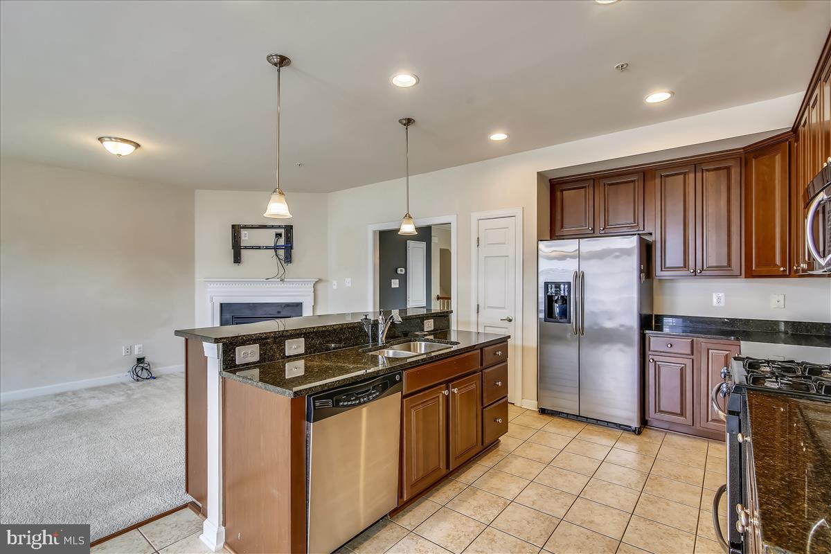 3602 Spring Hollow Lane Frederick, MD 21704 - Photo 8 of 25 a kitchen with stainless steel appliances granite countertop a stove a refrigerator a sink and dishwasher