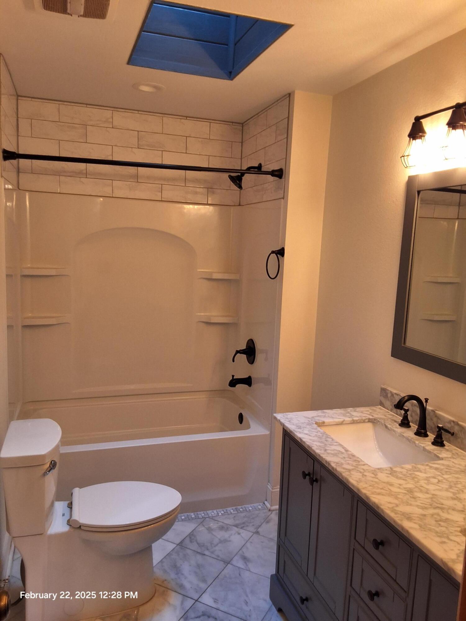 5652 Old Bethel Road Crestview, FL 32536 - Photo 13 of 23 a bathroom with a granite countertop sink toilet and shower