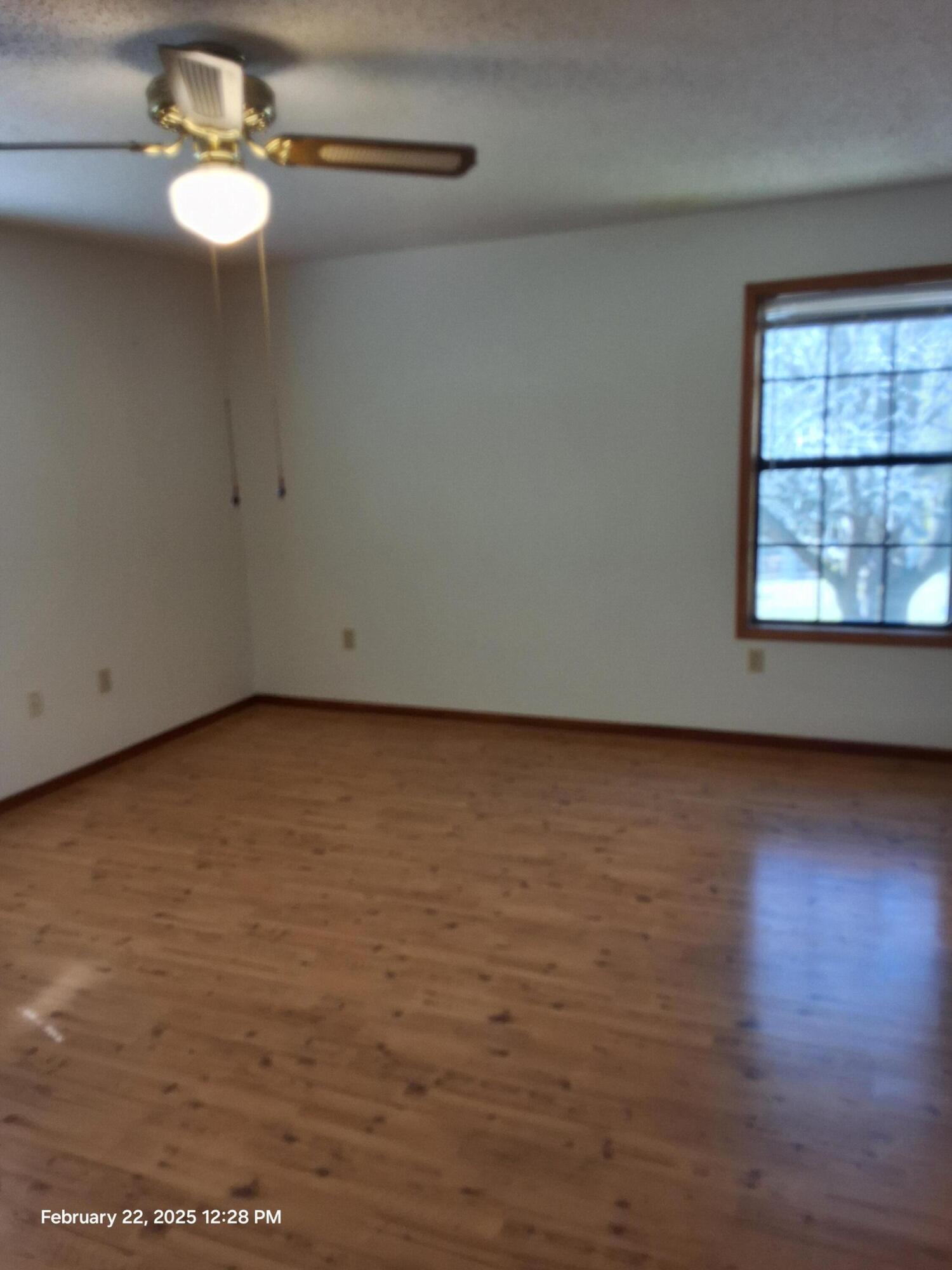 5652 Old Bethel Road Crestview, FL 32536 - Photo 16 of 23 wooden floor in an empty room with a window