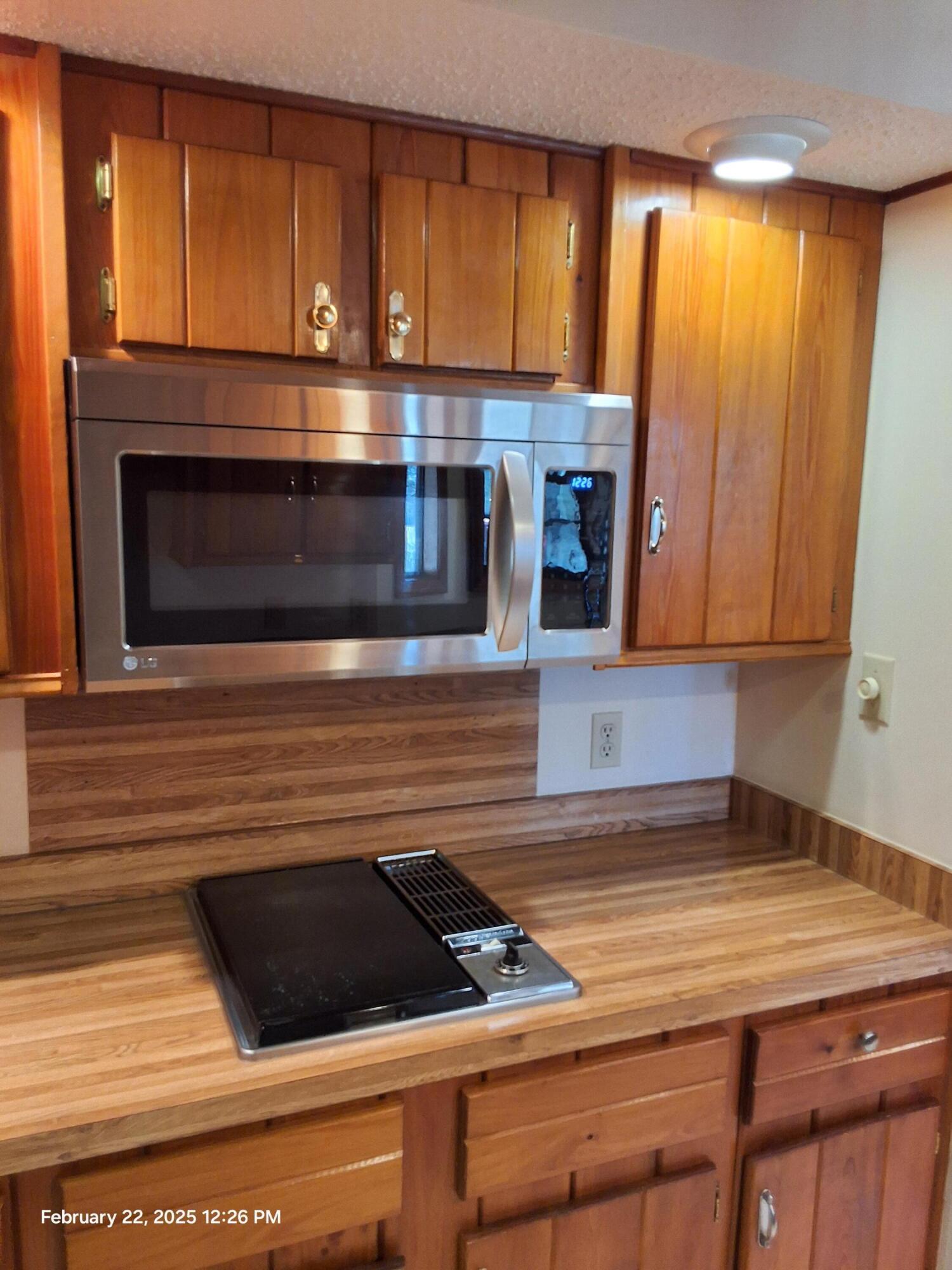 5652 Old Bethel Road Crestview, FL 32536 - Photo 4 of 23 a kitchen with granite countertop a stove and a microwave