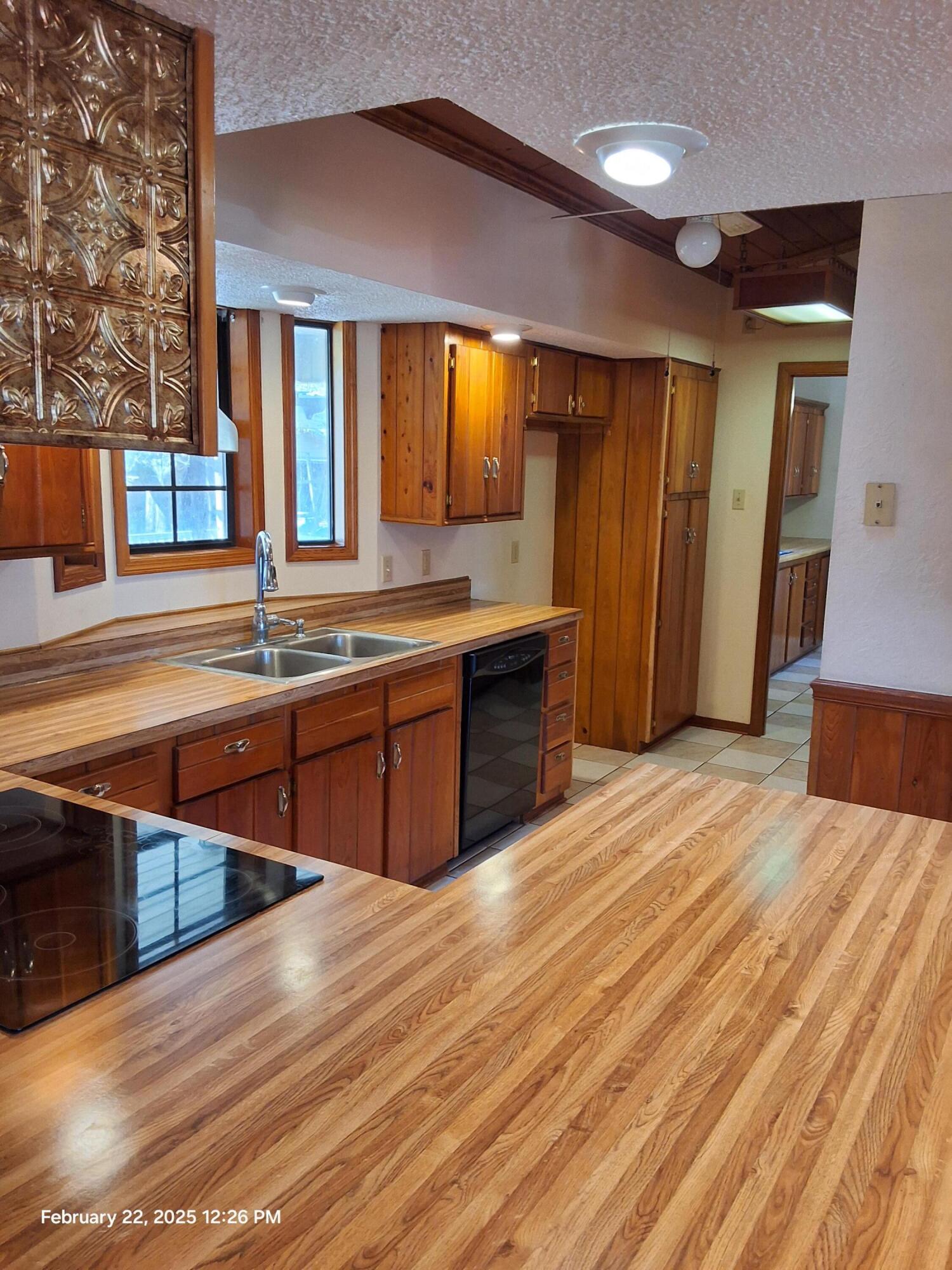 5652 Old Bethel Road Crestview, FL 32536 - Photo 6 of 23 a large kitchen with stainless steel appliances granite countertop a sink wooden cabinets and granite counter tops