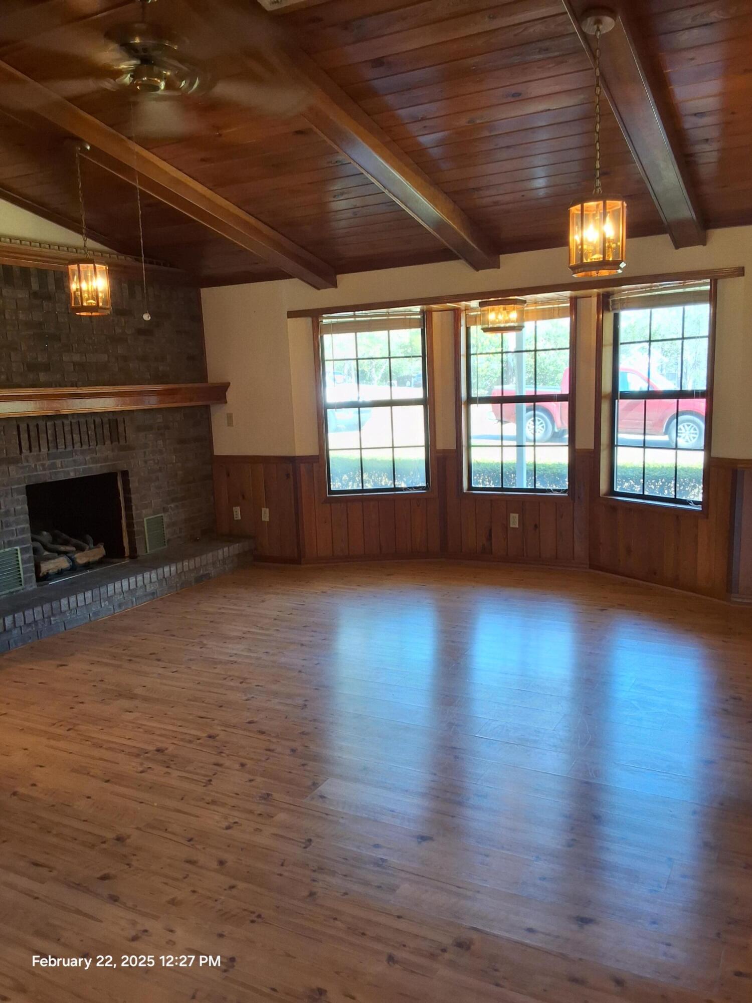 5652 Old Bethel Road Crestview, FL 32536 - Photo 7 of 23 an empty room with wooden floor and windows