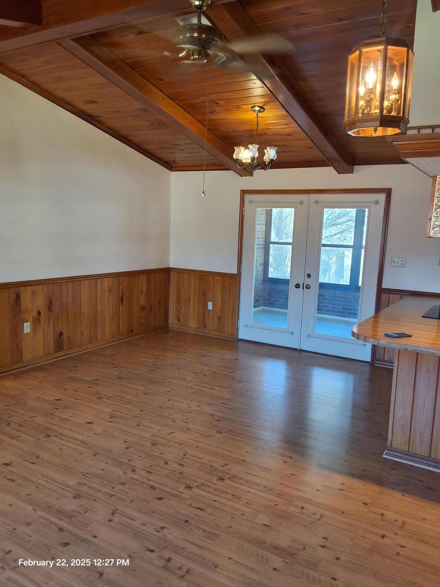 5652 Old Bethel Road Crestview, FL 32536 - Photo 8 of 23 a view of an empty room with wooden floor and a window