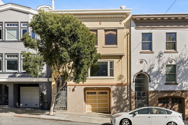 a view of a room with wooden floor and a large window