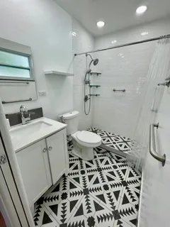 a bathroom with a sink toilet and shower