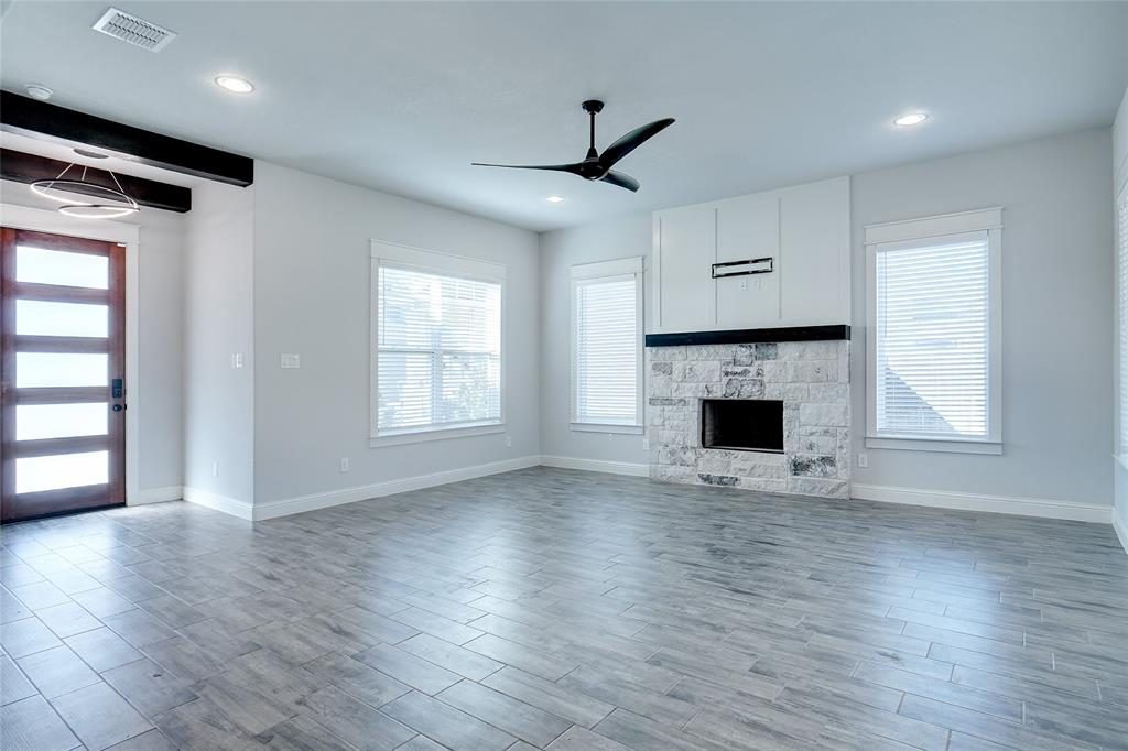 124 William Lane Godley, TX 76044 - Photo 11 of 32 a view of empty room with wooden floor and fireplace