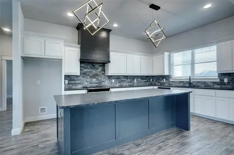 a kitchen with a sink cabinets and window
