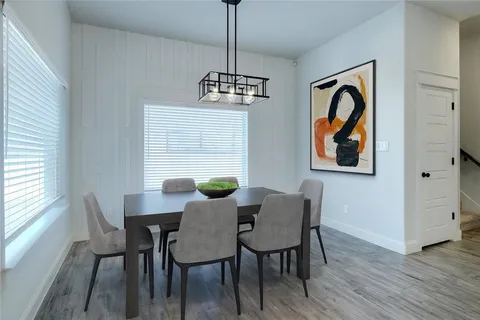 a view of a dining room with furniture window and wooden floor