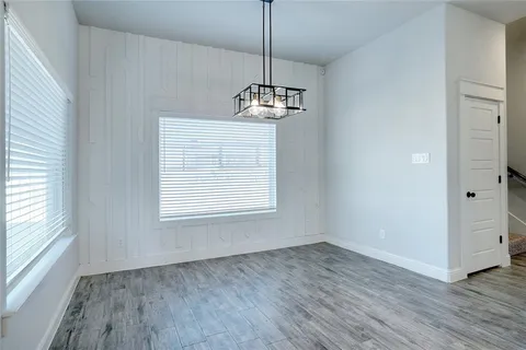 a view of a room with wooden floor cabinets and a window