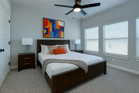 a bedroom with bed and window