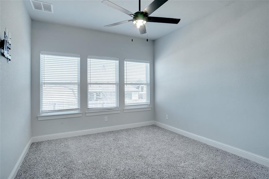 124 William Lane Godley, TX 76044 - Photo 23 of 32 an empty room with a window and a fan