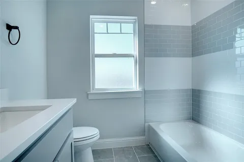 a bath room with a toilet and a bath tub
