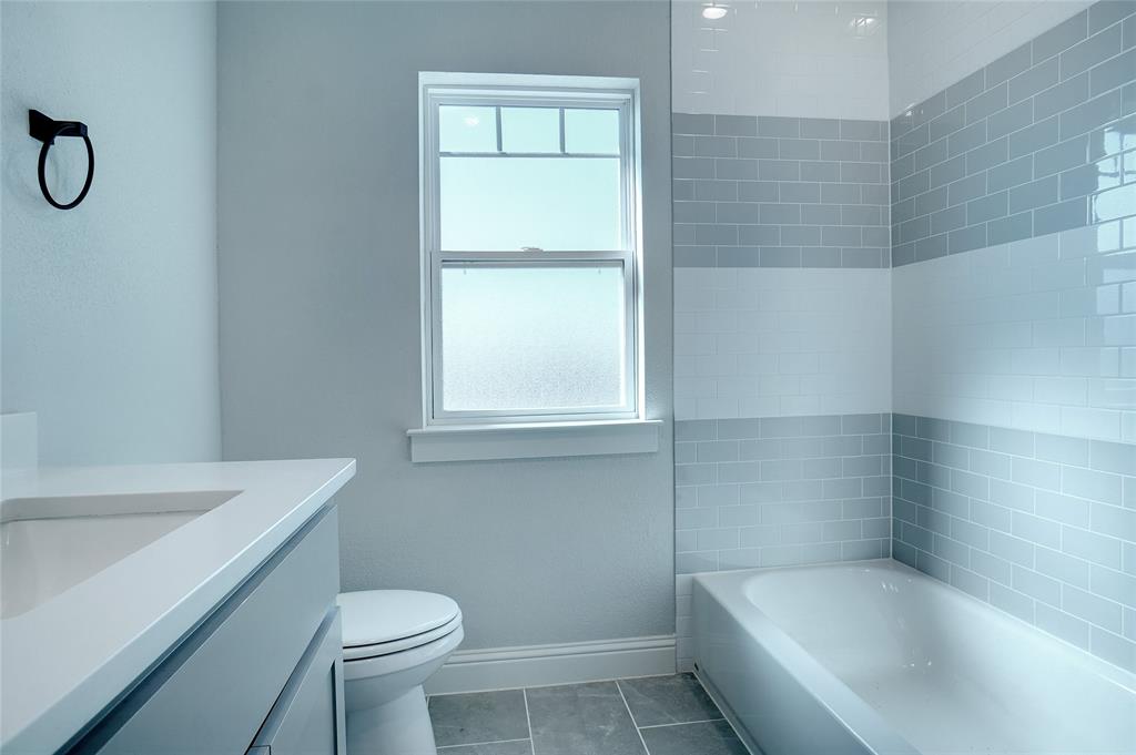 124 William Lane Godley, TX 76044 - Photo 25 of 32 a bath room with a toilet and a bath tub
