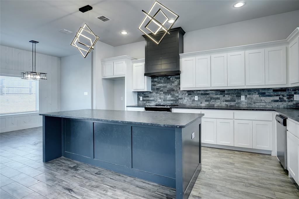 124 William Lane Godley, TX 76044 - Photo 9 of 32 a kitchen with stainless steel appliances granite countertop a sink a stove and a wooden floors