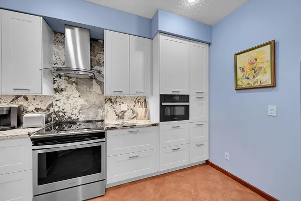 a kitchen with stainless steel appliances a stove a microwave and cabinets