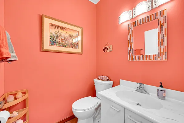 a bathroom with a sink mirror and toilet