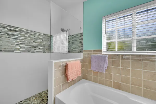 a bathroom with a bathtub sink and window