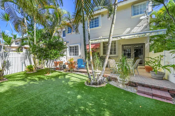 an aerial view of a house with garden space and street view