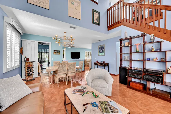 a living room with furniture a piano and a flat screen tv