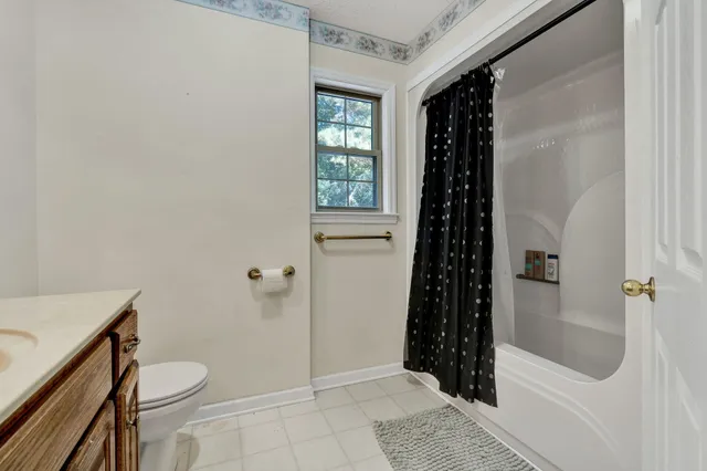 an empty room with chandelier fan