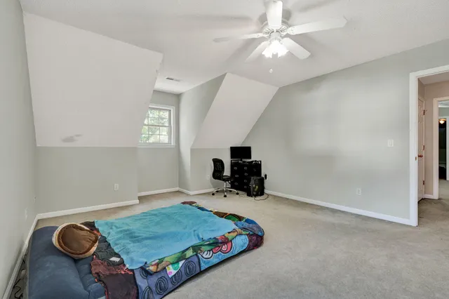 a view of an empty room with a ceiling fan