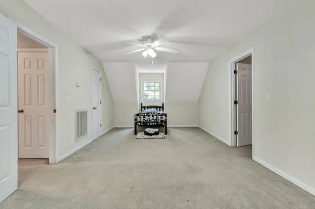 an empty room with fan and entrance