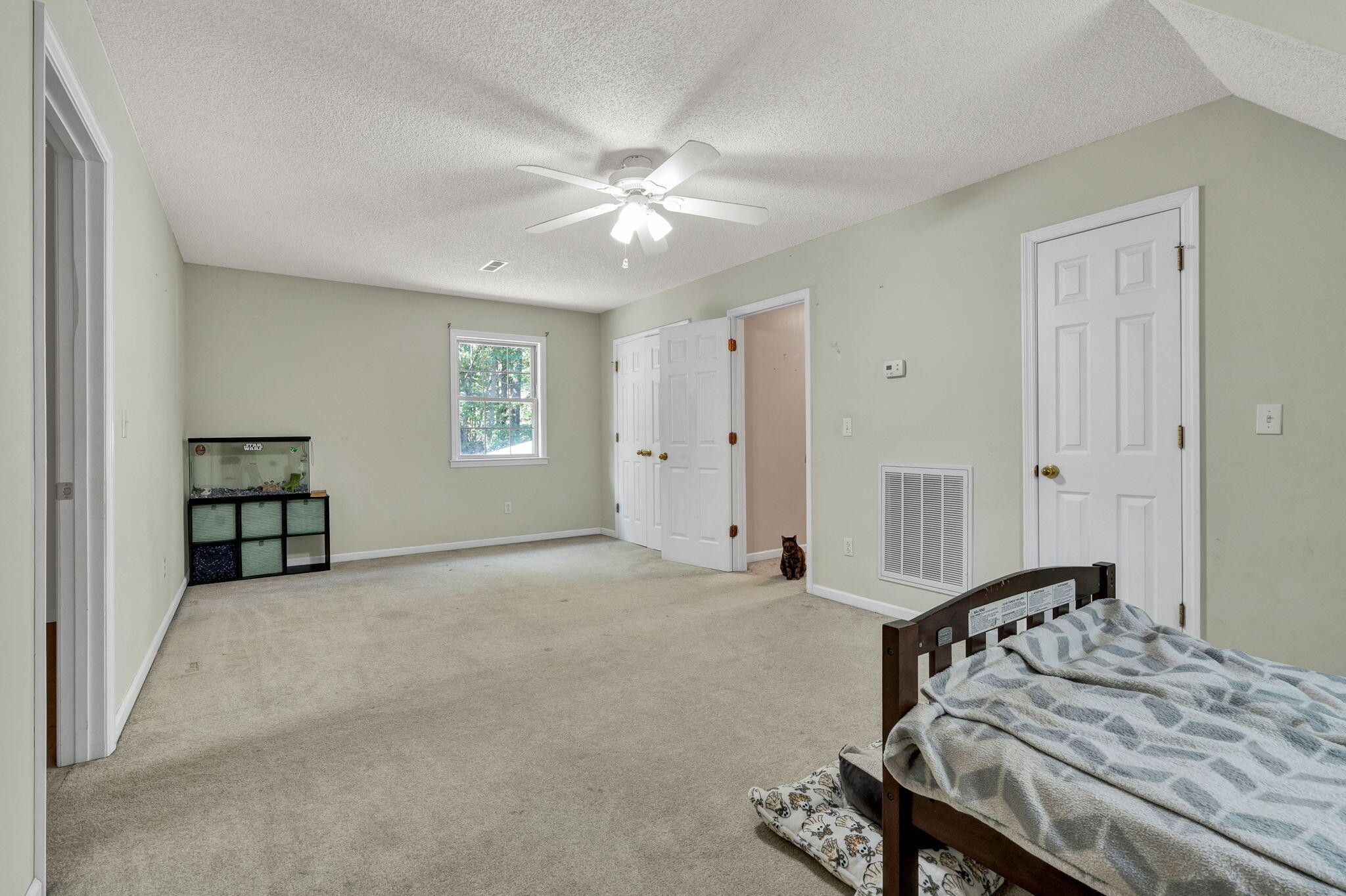 1582 Eads Bluff Road Northwest Georgetown, TN 37336 - Photo 30 of 57 a spacious bedroom with a bed and a chandelier