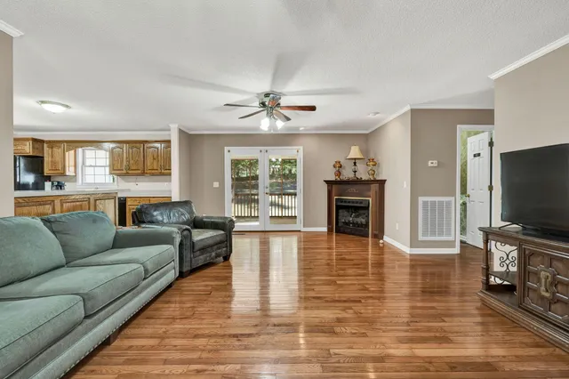 a living room with furniture flat screen tv and a fireplace