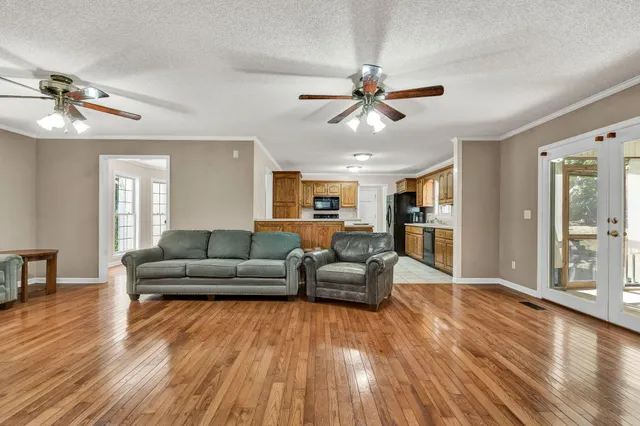 a living room with furniture and wooden floor