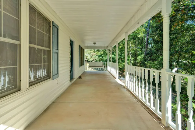 a view of a house with yard and sitting area