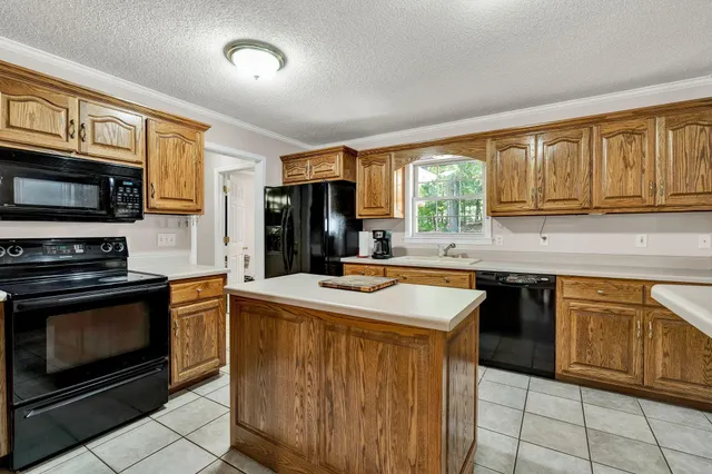 a view of a dining room with furniture wooden floor and chandelier