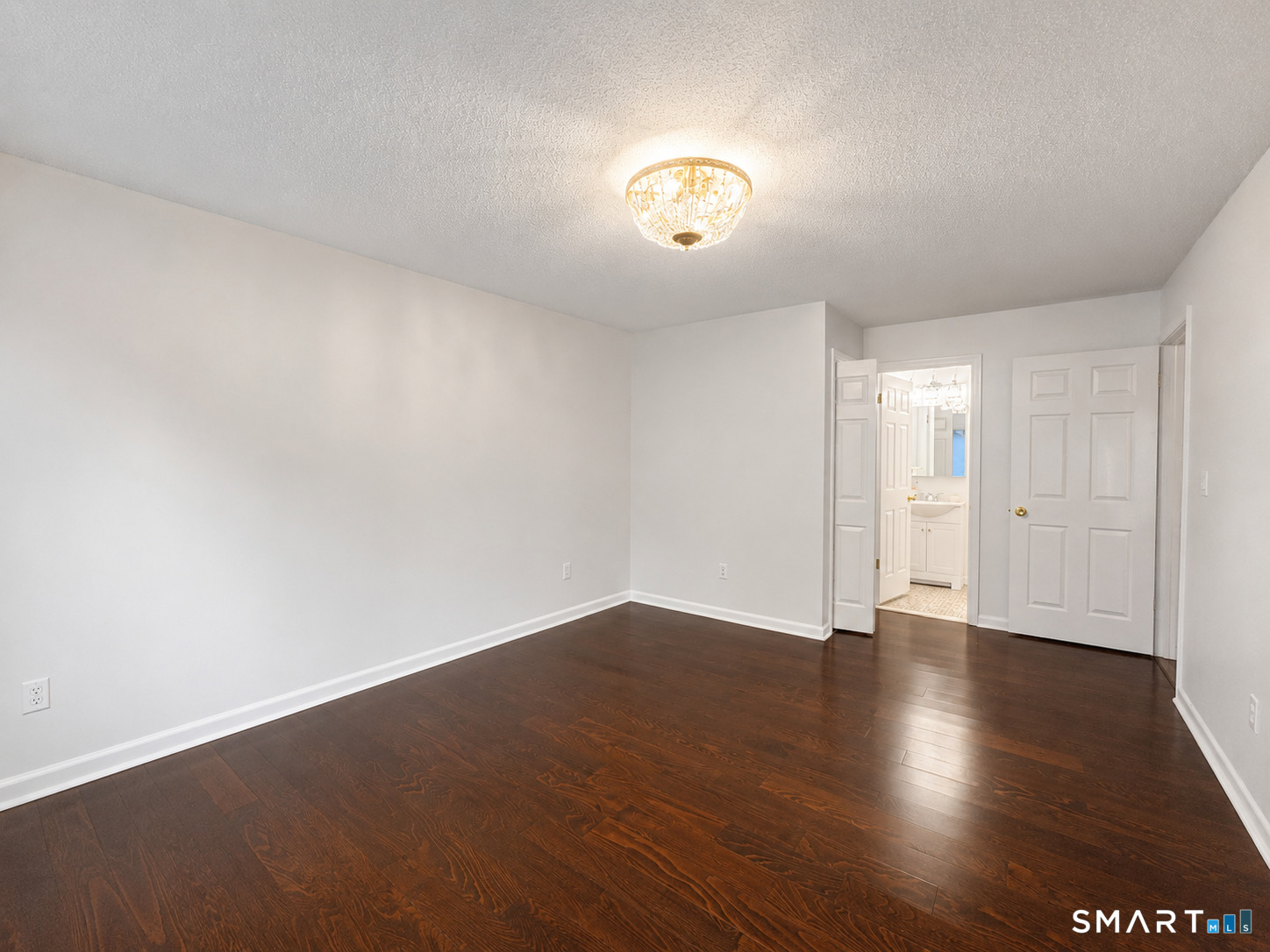 914 High Path Road, Unit 914 Windsor, CT 06095 - Photo 12 of 23 an empty room with wooden floor and windows
