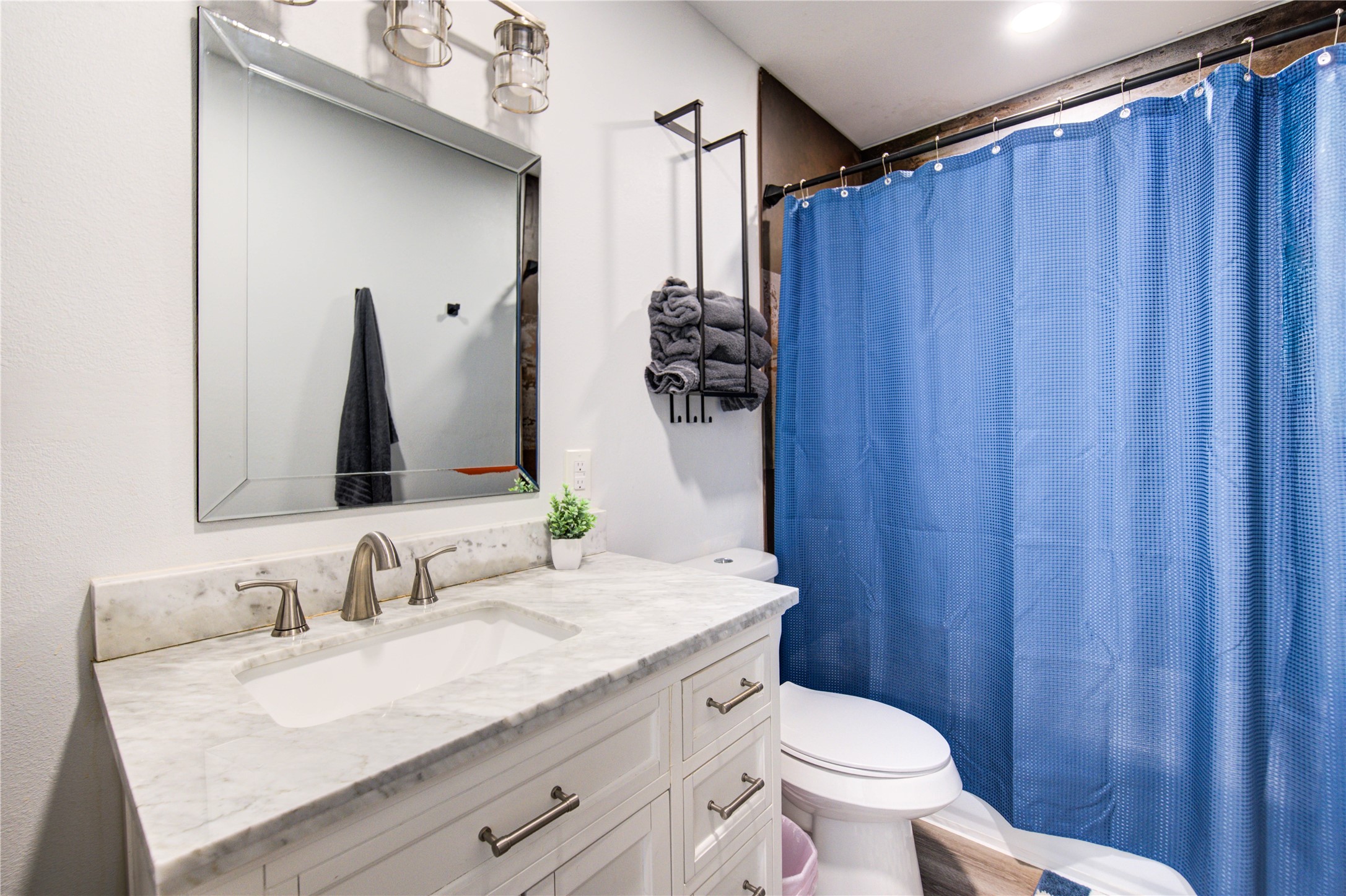 4049 Lucille Street, Unit B Houston, TX 77026 - Photo 12 of 16 a bathroom with a granite countertop sink and a mirror with toilet