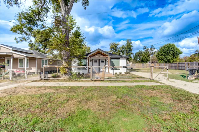a house view with swimming pool in front of it
