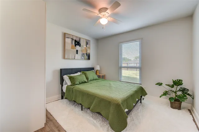 a bedroom with a bed and a potted plant