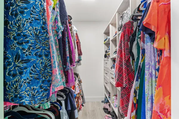 a view of walk in closet with clothes