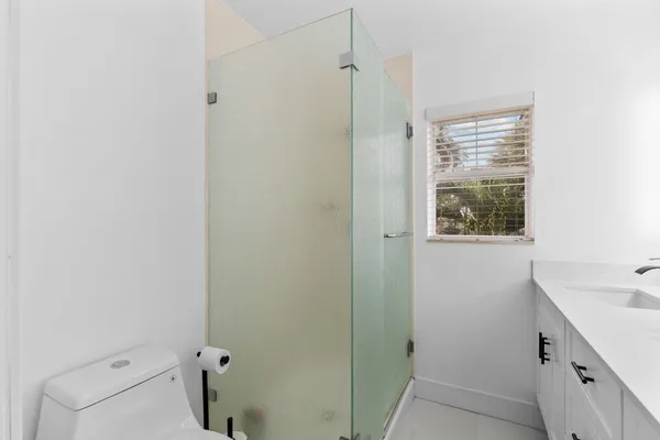 a bathroom with a sink a mirror and a shower