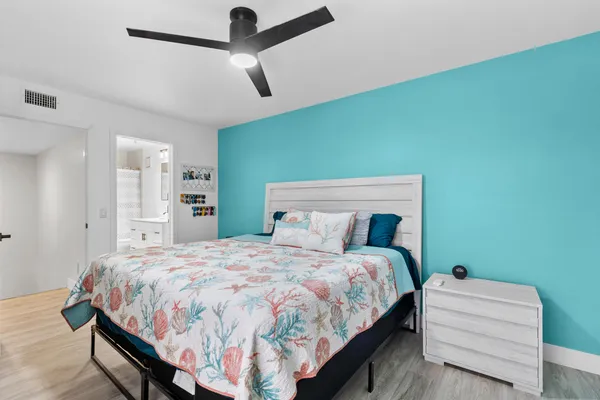 a bedroom with a bed and a mirror