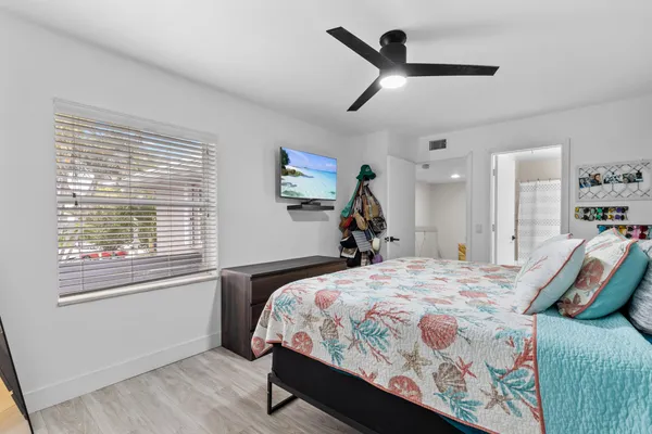 a bedroom with a bed dresser and a window