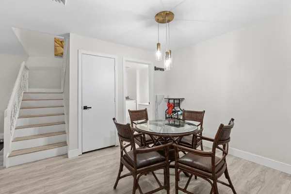 a view of a dining room with furniture and wooden floor