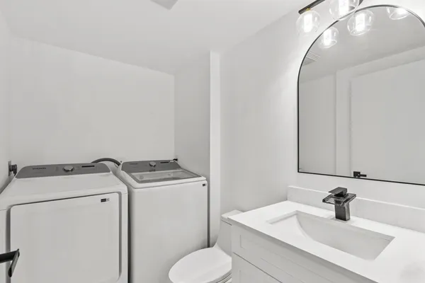 a bathroom with a sink toilet and mirror