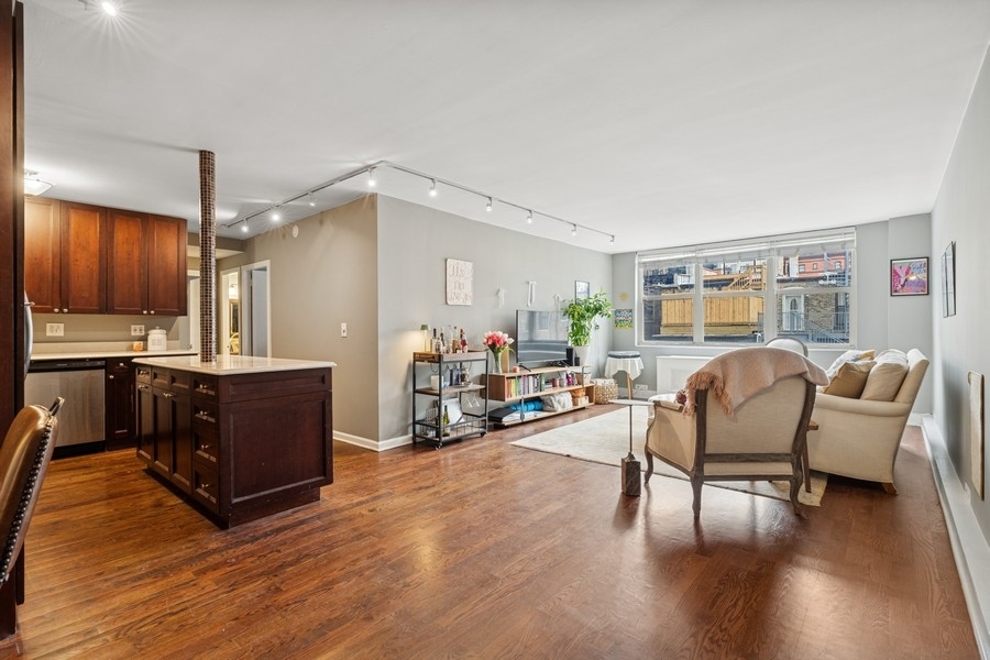 40 East Cedar Street, Unit 4D Chicago, IL 60611 - Photo 3 of 18 a living room with furniture and a wooden floor