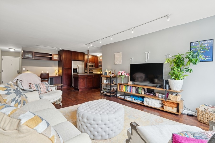 40 East Cedar Street, Unit 4D Chicago, IL 60611 - Photo 8 of 18 a living room with furniture and a flat screen tv