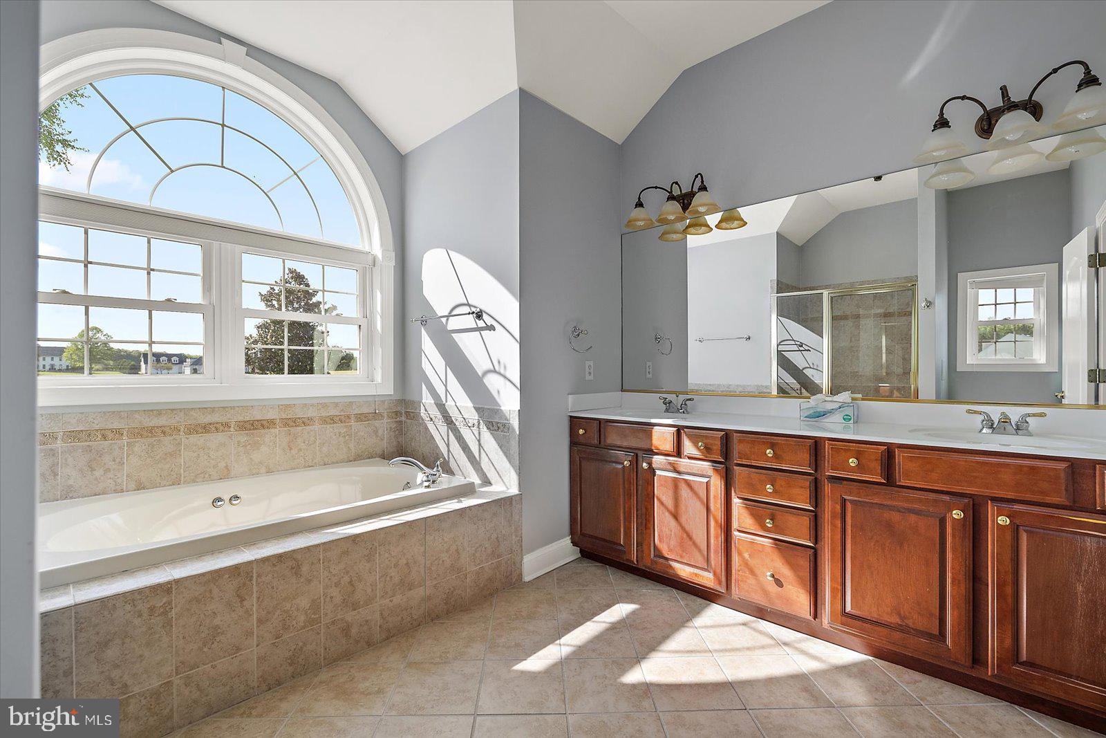 3431 Redden Ferry Road Eden, MD 21822 - Photo 47 of 103 a spacious bathroom with a tub a double vanity sink a mirror a window and a bathtub