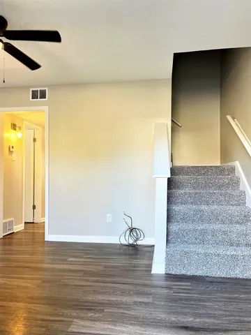 a view of a brick house with plants