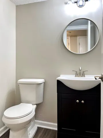 a bathroom with a toilet sink and mirror