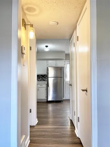 a view of a refrigerator in a kitchen