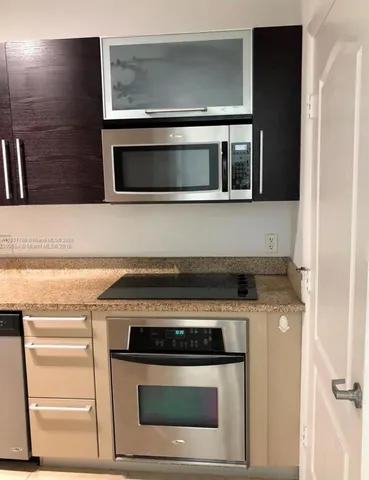 a stove top oven sitting inside of a kitchen